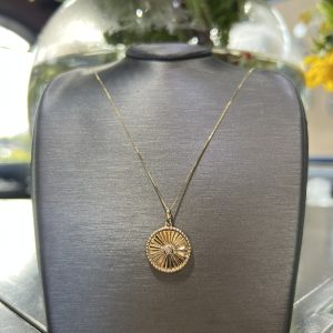 Diamond and gold round shaped medallion